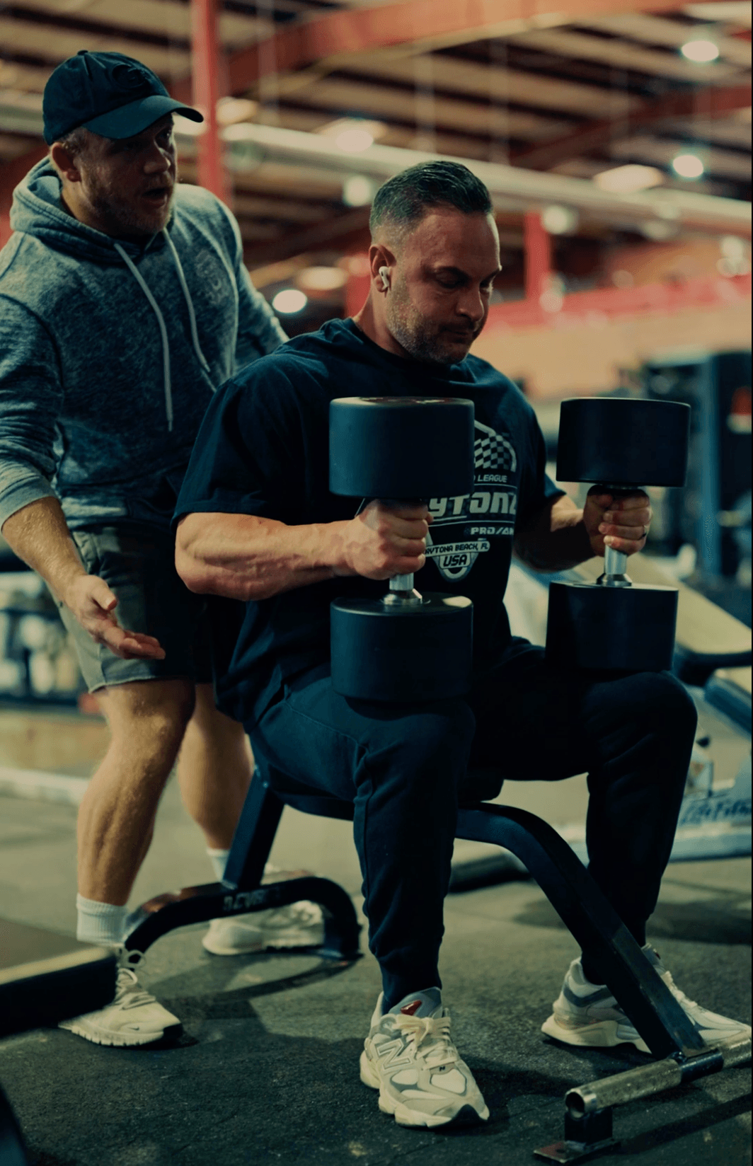 Personal training client performing dumbbell press